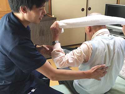 座りやすいように車椅子を調節しています。